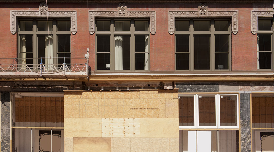 older building under constuction boarded up for redevelopment culture at sendero cross capital company in dallas texas